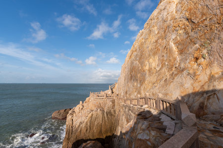 Stones of various shapes weathered by the sea under the blue skyの写真素材