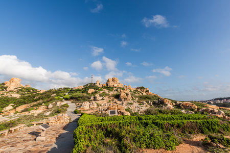 Stones of various shapes weathered by the sea under the blue skyの写真素材