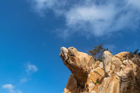 Stones of various shapes weathered by the sea under the blue skyの写真素材