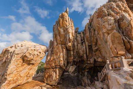 Stones of various shapes weathered by the sea under the blue skyの写真素材