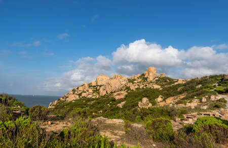 Stones of various shapes weathered by the sea under the blue skyの写真素材