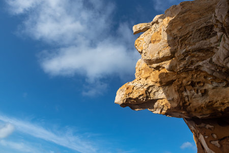 Stones of various shapes weathered by the sea under the blue skyの写真素材