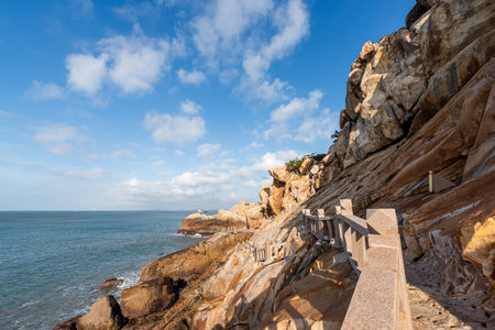 Stones of various shapes weathered by the sea under the blue skyの写真素材