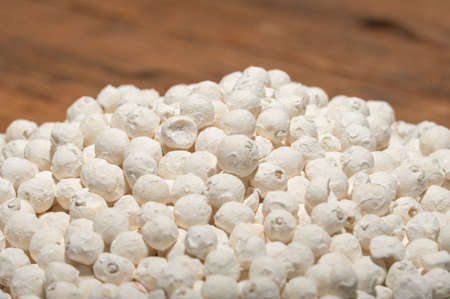 Gorgon fruit in a bowl or plate on a wood grain tableの写真素材