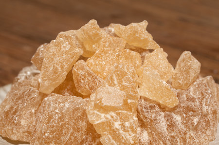 The rock sugar in the container is on the wood grain tableの写真素材