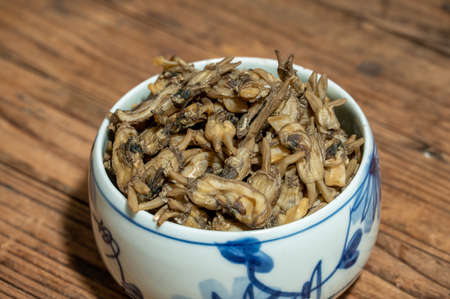 Dried razor clams in containers on wood grain countertopsの写真素材