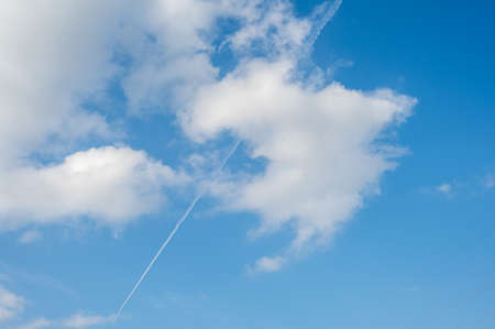 The plane's wake across the sky is like a cloudの写真素材