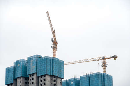 On cloudy days, high-altitude boom on high-rise buildings in modern cities under constructionの写真素材