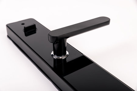 A metal Intelligent lock made of black paint is locked on a white background