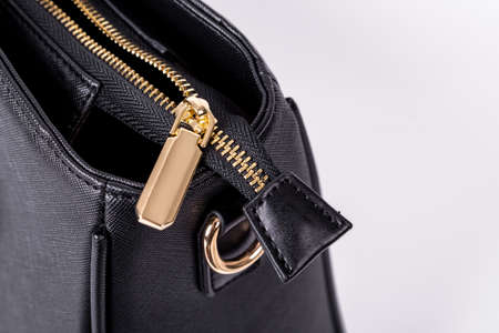 The details and workmanship of a black leather bag are on a white backgroundの写真素材
