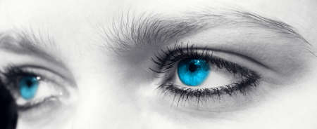 Blue eyes of a young woman in black and white.の写真素材