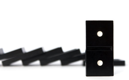 all domino pieces fell down. One stands still in front. Isolated.の写真素材