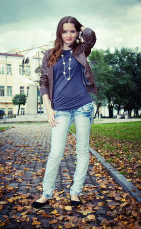 Young sexy woman stands in leavesの写真素材