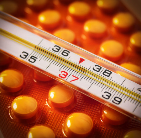 Medicine concept through thermometer and pack of pills
