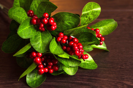 Berries red currants in an old wooden spoon. Red currant on a branch with leaves on turquoise wooden...