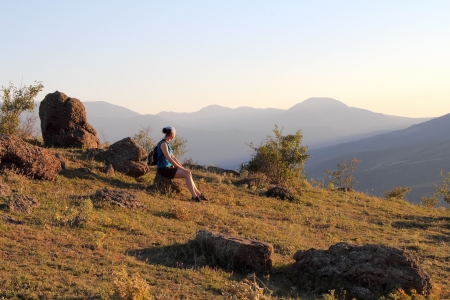 Girl on a rock in the valleyの写真素材