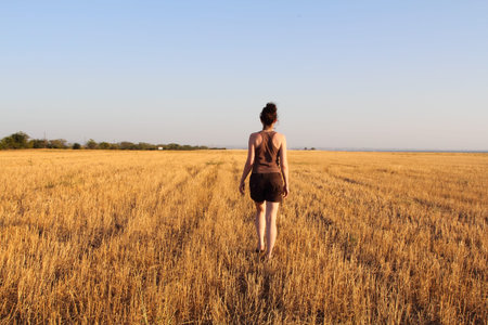 Girl goes on a fieldの写真素材