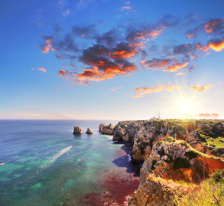 Rocky beach at sunset, Lagos, Portugal. Counter light. Travel and business backgroundの写真素材