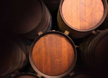 Row of wooden barrels of tawny portwine (port wine) in cellar, Porto, Portugal. Vintage old styleの写真素材
