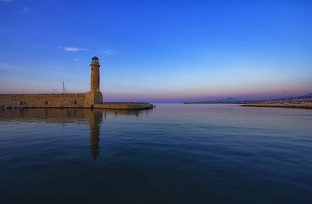 Magnificent view of Lighthouse and  old port, Retimno, Crete, Greece during a beautiful sunset in the Mediterranean. Love and travel backgroundの写真素材