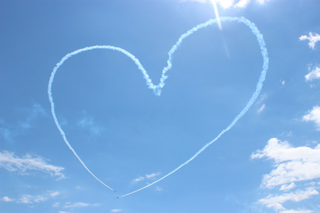 Heart painted by airplane in the skyの写真素材