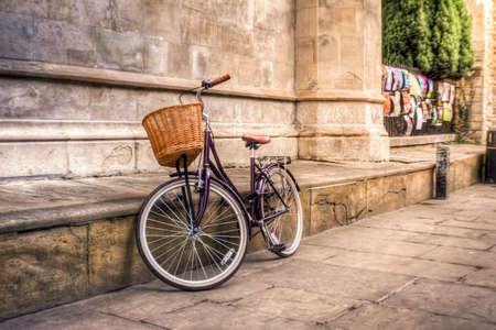 Purple vintage bicycle in an iconic old street of Cambridgeの写真素材