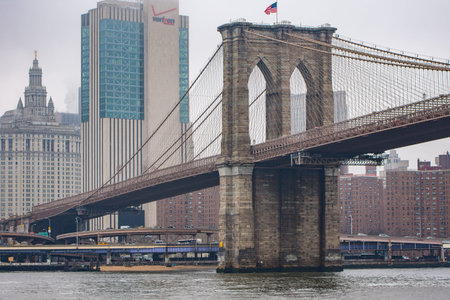 New York, US - March 29, 2018:  Brooklyn bridge on a foggy day in New York as seen from a promenade in Brooklynのeditorial素材