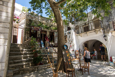 Apiranthos, Naxos / Greece - July 13, 2019: Toutists visiting the narrow streets and shops of Apiranthos, the Marble village in central Naxos, Greeceのeditorial素材