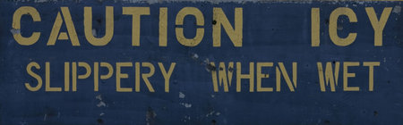 Caution Icy Slippery When Wet painted on cement in yellow.