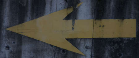 Yellow arrow painted on cement.の写真素材