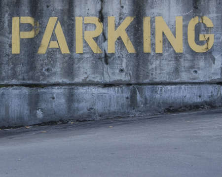 Parking sign painted on cement in yellow.の写真素材