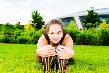 The young beautiful girl doing gymnastics outdoorsの写真素材