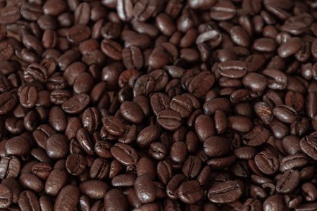 Brown Roasted Coffee Beans Closeup On Dark Backgroundの写真素材