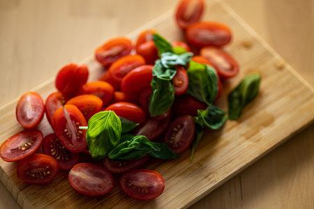 Cherry tomato and basil on wooden backgroundの写真素材