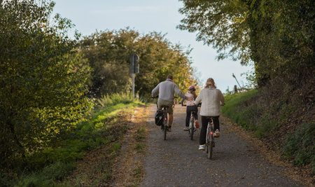 Family enjoying bike ride in park. Weekend bike riding.の写真素材