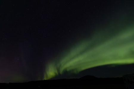 Aurora borealis over in the dark night. The dark sky and filled with starsの写真素材