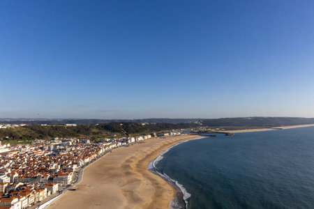 Scenic Aerial View of Coastal Beach City and Vast Blue Ocean Horizonの写真素材