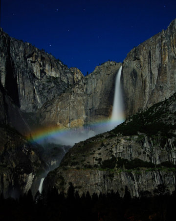 Moonbow caused by the bright moon light and the mist of the Yosemite Falls. Can be seen clearly at night.の写真素材