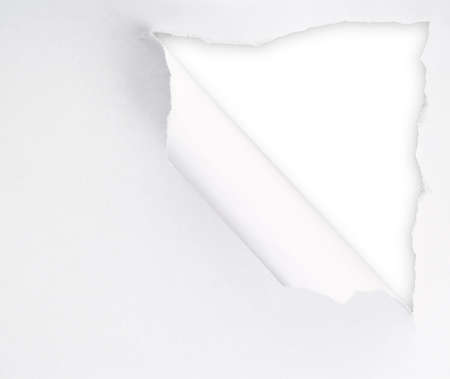 Torn paper sheet with an empty gap hole as a copyspace backgroundの写真素材