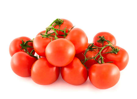 Pile of red tomato bunches isolated over white backgroundの写真素材