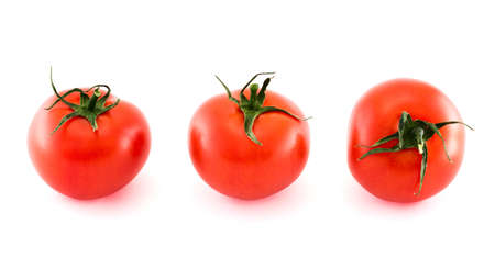 Three fresh tomatos in different foreshortenings isolated over white backgroundの写真素材