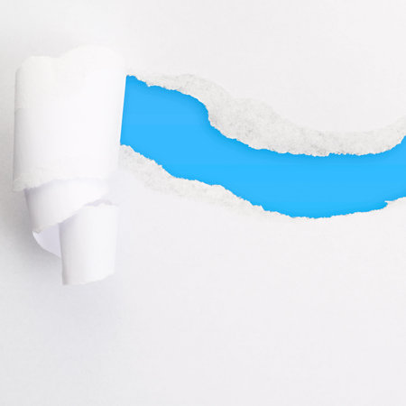 Torn paper sheet with an empty blue colored gap hole as a copyspace backgroundの写真素材