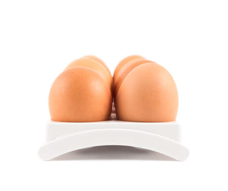Dozen, twelve eggs in a special plastic case isolated over white background, close-up front viewの写真素材
