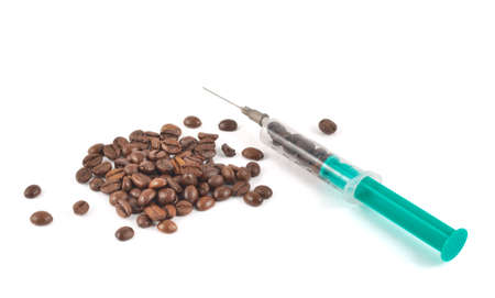 Coffee addict concept: medical syringe full of coffee beans isolated over white backgroundの写真素材