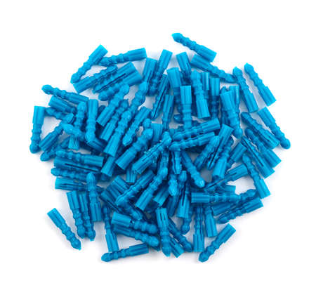 Blue plastic dowel pin pile isolated over white background, above close-upの写真素材