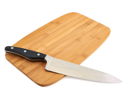 Cook's kitchen knife over wooden cutting board isolated against white background