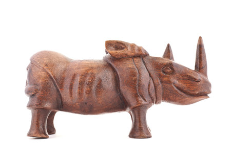 Rhinoceros rhino sculpture made of carved varnished brown wood isolated over white backgroundの写真素材