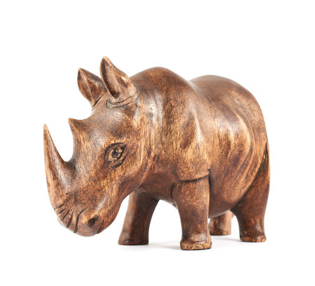 Rhinoceros rhino sculpture made of carved varnished brown wood isolated over white backgroundの写真素材