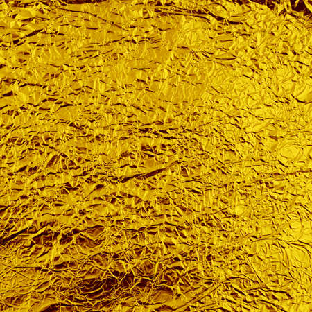Creased aluminum golden foil background textureの写真素材