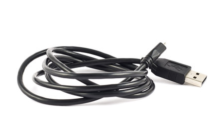 Coiled black USB cable isolated over white background